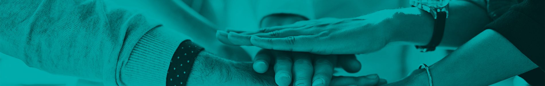 Shot of a group of colleagues joining hands in solidarity outdoors